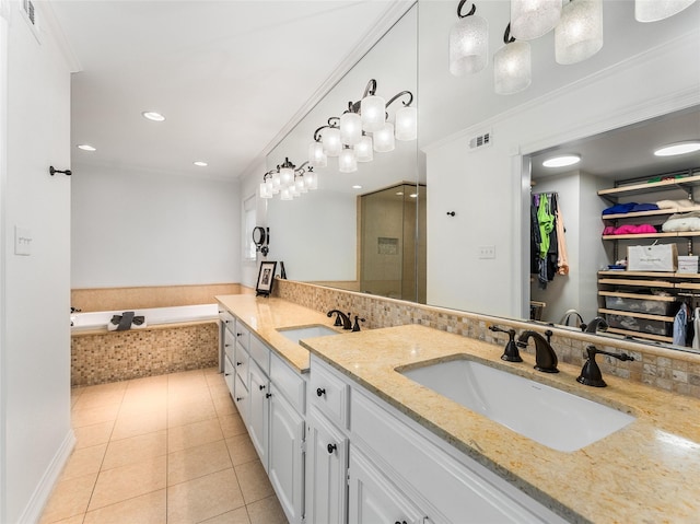 bathroom featuring crown molding, vanity, tiled tub, tile patterned flooring, and backsplash