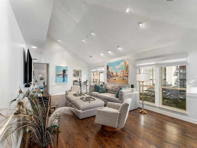 living room with plenty of natural light, dark wood-type flooring, and high vaulted ceiling