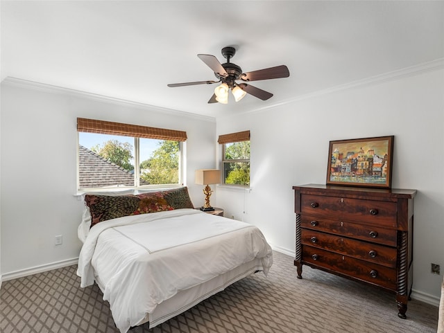 bedroom with ceiling fan, ornamental molding, and carpet floors