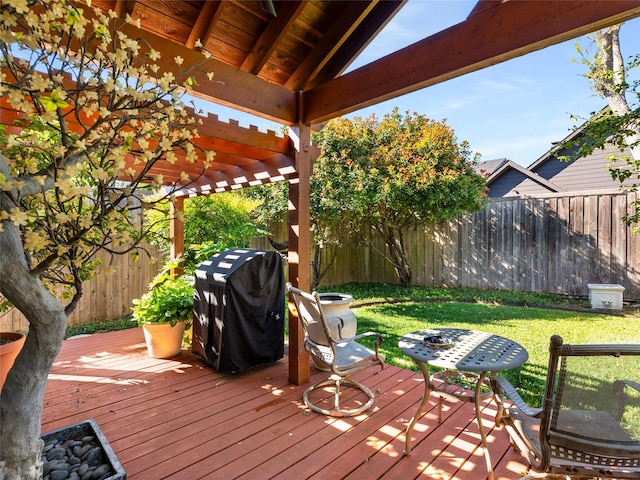 wooden deck with a pergola, grilling area, and a lawn