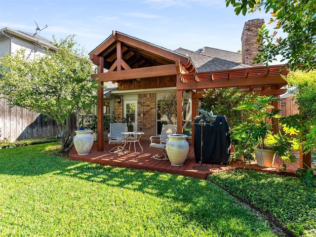 rear view of property featuring a wooden deck and a yard