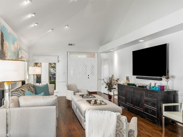 living room featuring dark hardwood / wood-style flooring and high vaulted ceiling