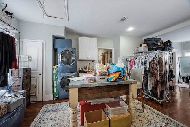 walk in closet with dark hardwood / wood-style floors and stacked washer and clothes dryer