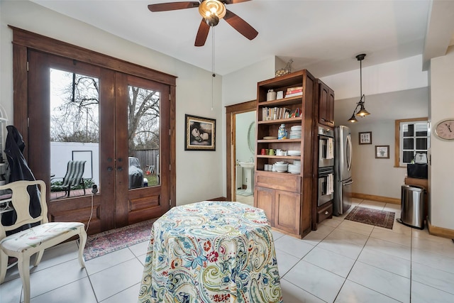 living area featuring light tile patterned floors, ceiling fan, and french doors