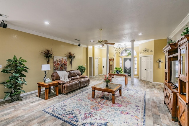 living area with light wood-style floors, a ceiling fan, and ornamental molding