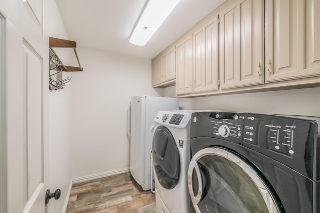 808 Majestic Oaks Ct, Mansfield, TX 76063 - laundry room featuring cabinet space, washing machine and dryer, and light wood-style floors
