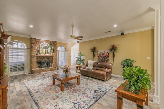 808 Majestic Oaks Ct, Mansfield, TX 76063 - living area with plenty of natural light, a ceiling fan, a brick fireplace, ornamental molding, and light wood-style flooring