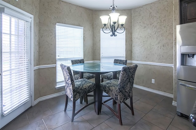 tiled dining space featuring a chandelier