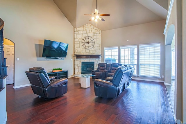 living room featuring a fireplace, dark hardwood / wood-style floors, and high vaulted ceiling