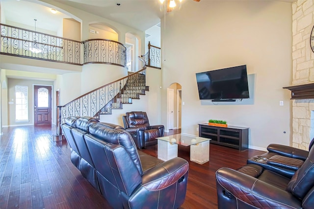 living room featuring a high ceiling and dark hardwood / wood-style floors