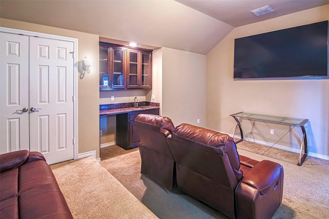 interior space featuring lofted ceiling and wet bar