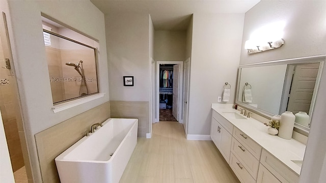 bathroom featuring independent shower and bath, vanity, and hardwood / wood-style floors