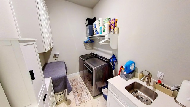 laundry area featuring cabinets, sink, and washing machine and dryer