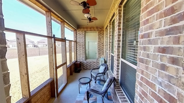 sunroom / solarium featuring ceiling fan