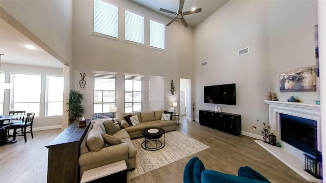 living room featuring light hardwood / wood-style floors and ceiling fan