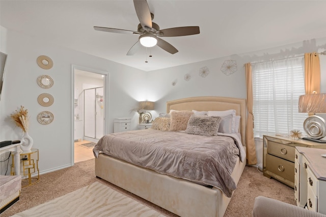 carpeted bedroom featuring ensuite bath and ceiling fan