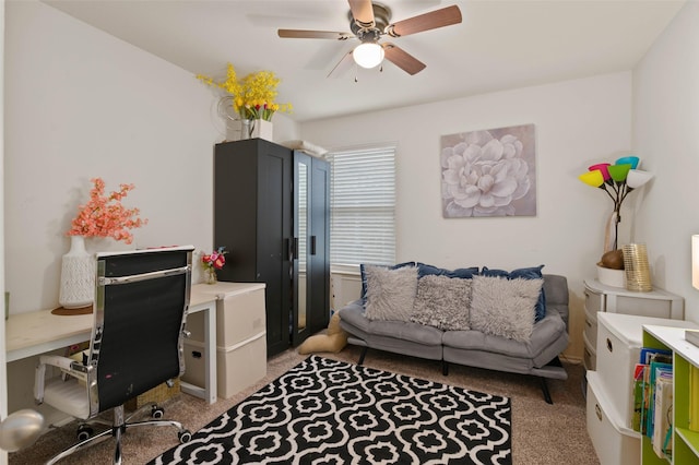 carpeted home office featuring ceiling fan