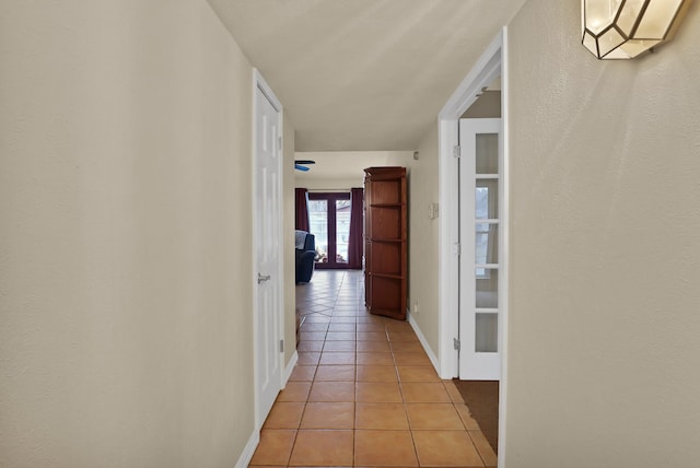 hall featuring light tile patterned flooring