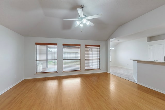 spare room featuring ceiling fan, vaulted ceiling, and light hardwood / wood-style flooring