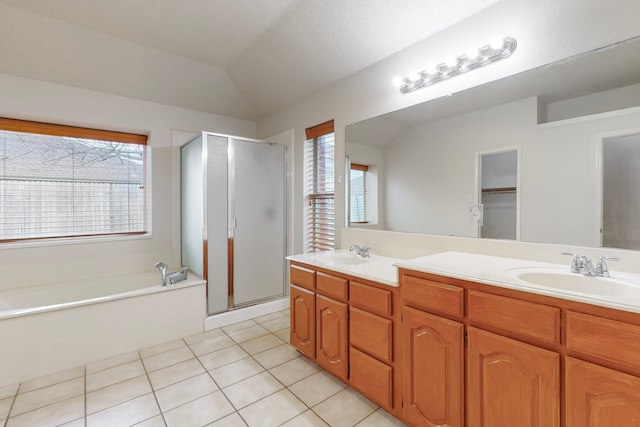 bathroom with shower with separate bathtub, lofted ceiling, tile patterned floors, and vanity