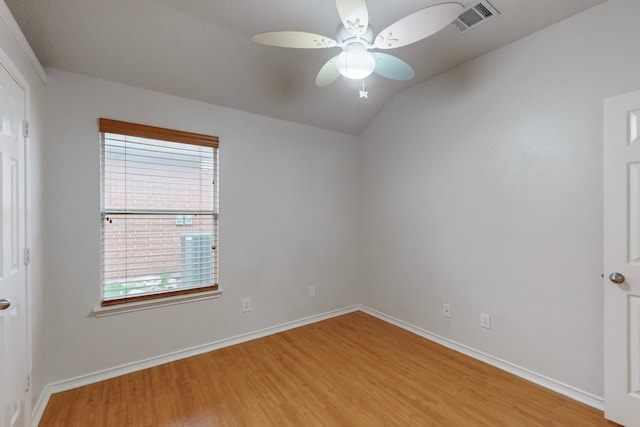 spare room with light hardwood / wood-style flooring, ceiling fan, and vaulted ceiling