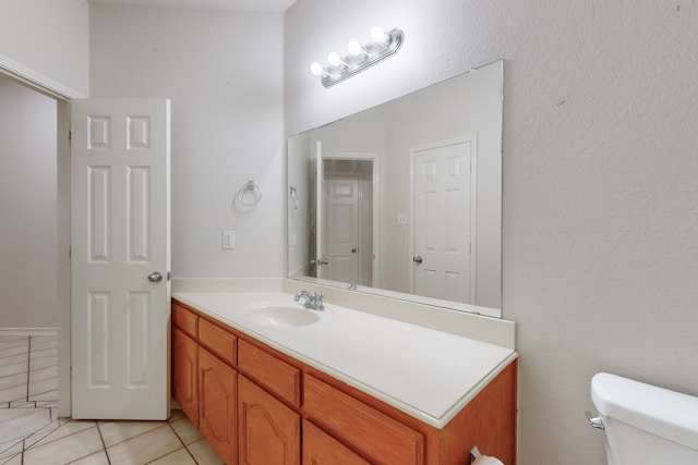 bathroom featuring vanity, toilet, and tile patterned flooring