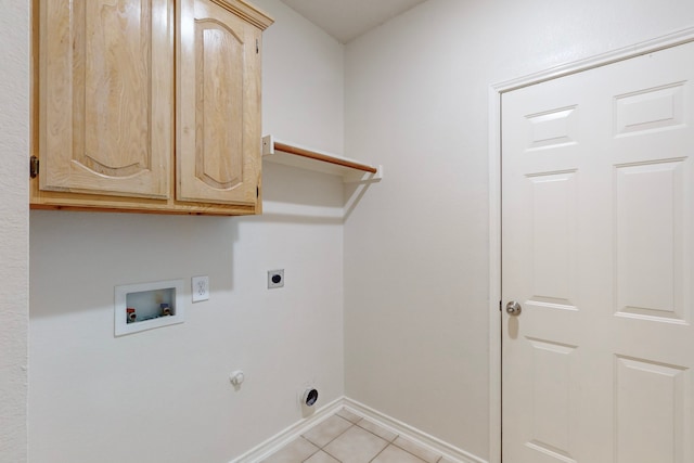 laundry room with light tile patterned flooring, gas dryer hookup, cabinets, washer hookup, and electric dryer hookup