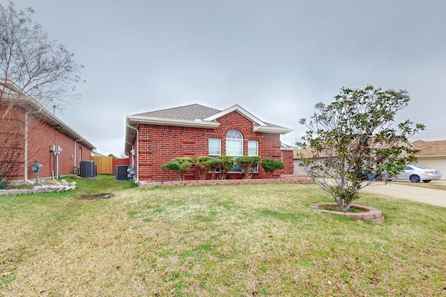 ranch-style house with cooling unit and a front yard