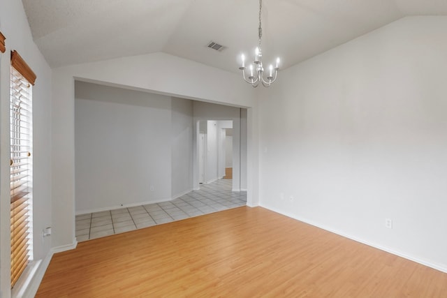 3821 Red Oak St, Sachse, TX 75048 - spare room featuring vaulted ceiling, light wood-style flooring, a chandelier, and baseboards
