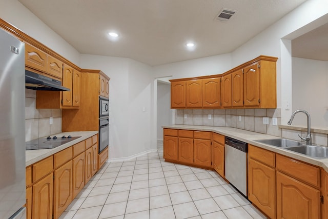 kitchen with light tile patterned floors, sink, decorative backsplash, and black appliances