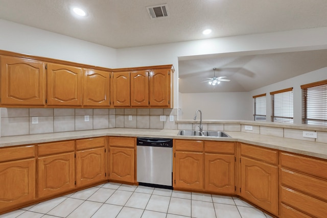 kitchen featuring light tile patterned flooring, tasteful backsplash, dishwasher, sink, and ceiling fan