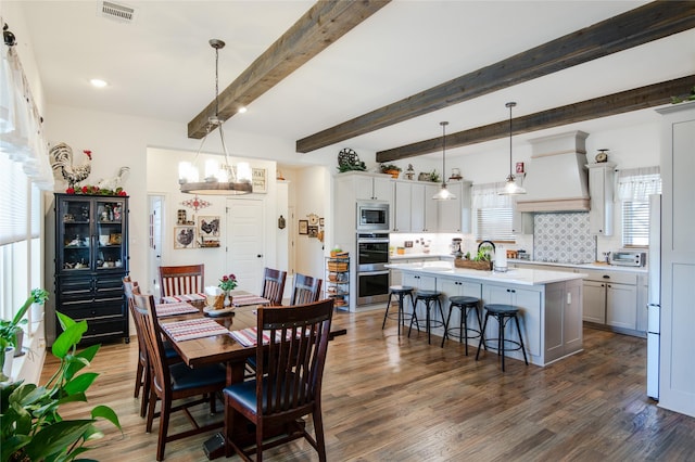 dining room featuring a chandelier, dark hardwood / wood-style floors, and beamed ceiling