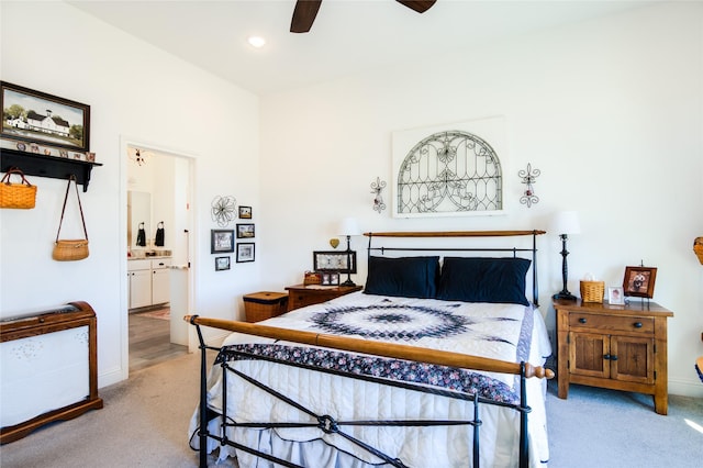 carpeted bedroom featuring ceiling fan and ensuite bath