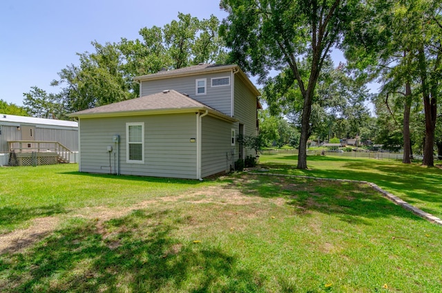 back of property featuring a lawn