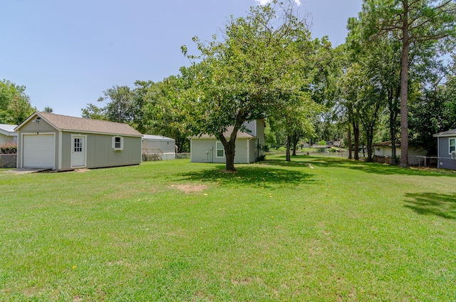 view of yard with a garage and an outdoor structure