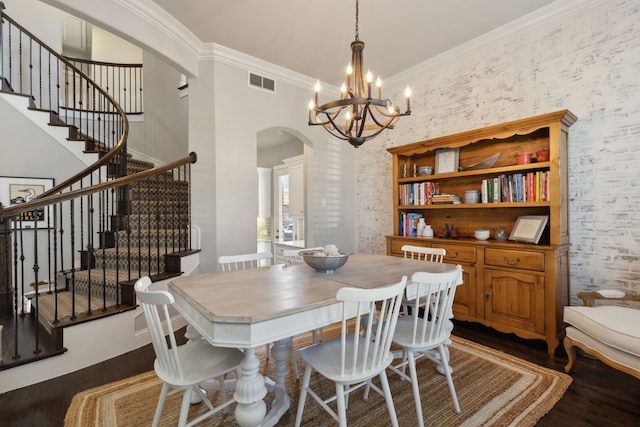 dining room with visible vents, arched walkways, dark wood-type flooring, and ornamental molding