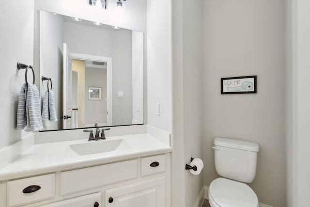 half bath with vanity and toilet