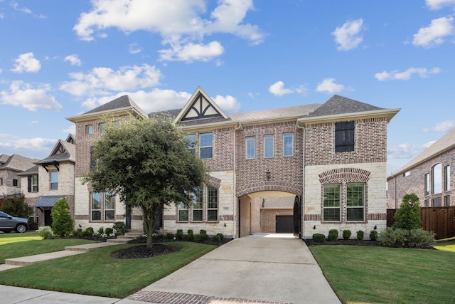 view of front facade with stone siding, a front lawn, concrete driveway, and brick siding