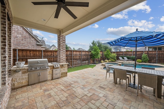 view of patio with a fenced in pool, area for grilling, a ceiling fan, exterior kitchen, and a fenced backyard