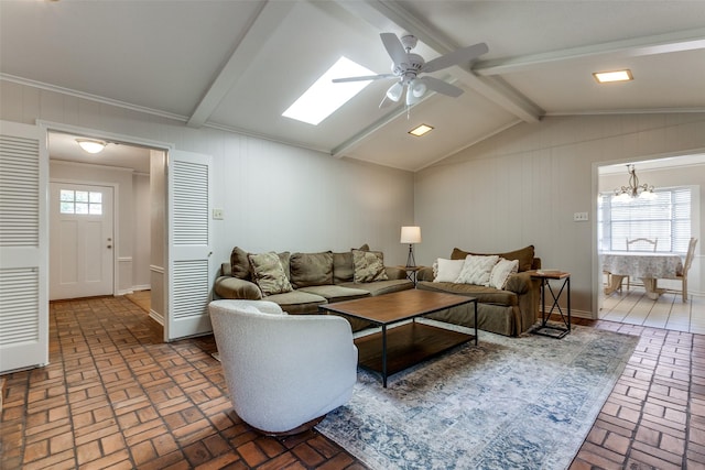 living room featuring ceiling fan with notable chandelier and lofted ceiling with beams