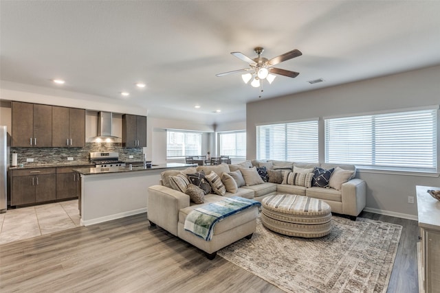 living room with ceiling fan and light hardwood / wood-style floors