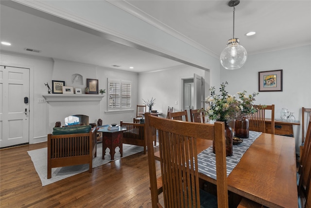 dining space with crown molding and dark hardwood / wood-style floors