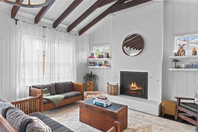 living room featuring vaulted ceiling with beams and a brick fireplace