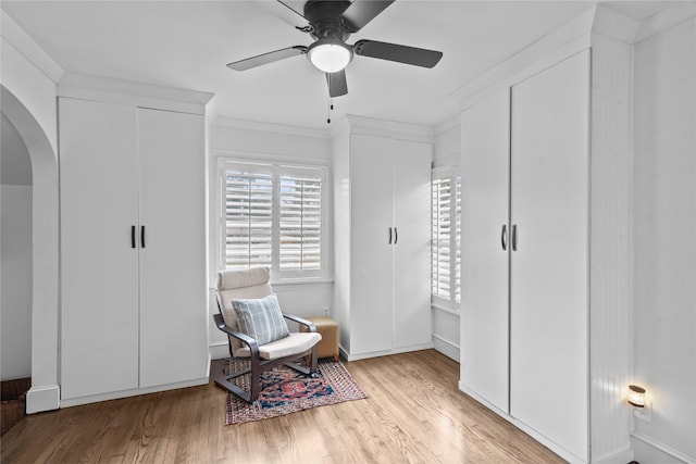 sitting room with crown molding, light hardwood / wood-style floors, and ceiling fan