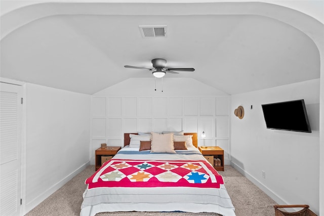 bedroom featuring light carpet, vaulted ceiling, and ceiling fan