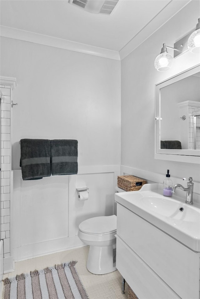 bathroom featuring crown molding, vanity, tile patterned floors, and toilet