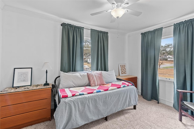 bedroom with multiple windows, crown molding, and light colored carpet