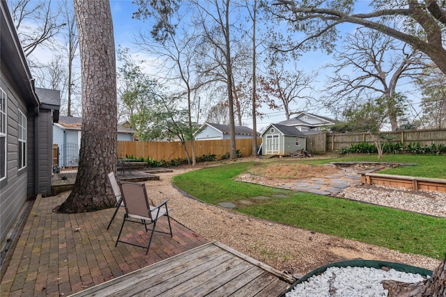 view of yard with a storage unit and a patio