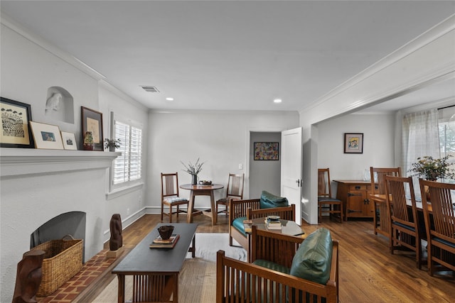 living room with hardwood / wood-style flooring and ornamental molding