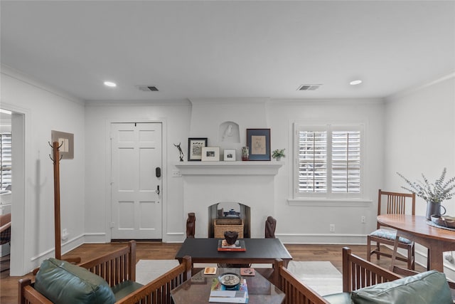 living room featuring crown molding and hardwood / wood-style floors